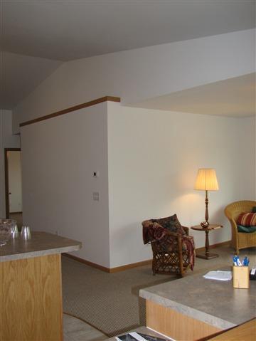 interior space featuring lofted ceiling and baseboards