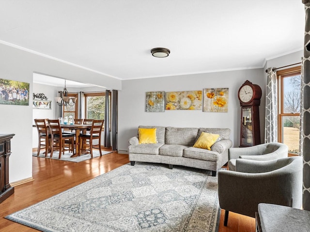 living room featuring baseboards, ornamental molding, and wood finished floors