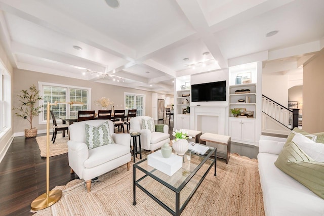 living room featuring dark wood-style floors, coffered ceiling, stairs, and beam ceiling