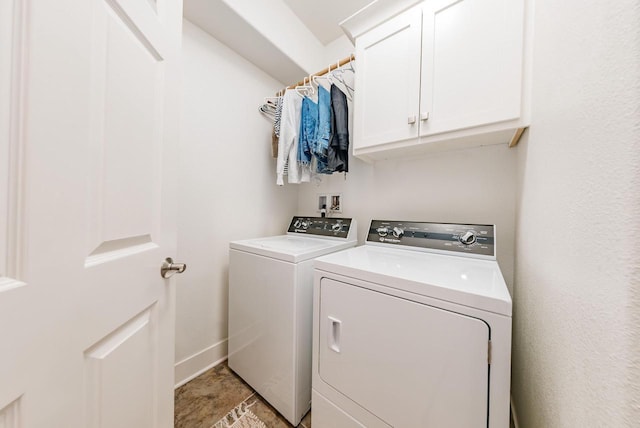 laundry room with cabinet space, baseboards, and washer and dryer