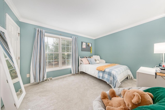 carpeted bedroom with ornamental molding, visible vents, and baseboards