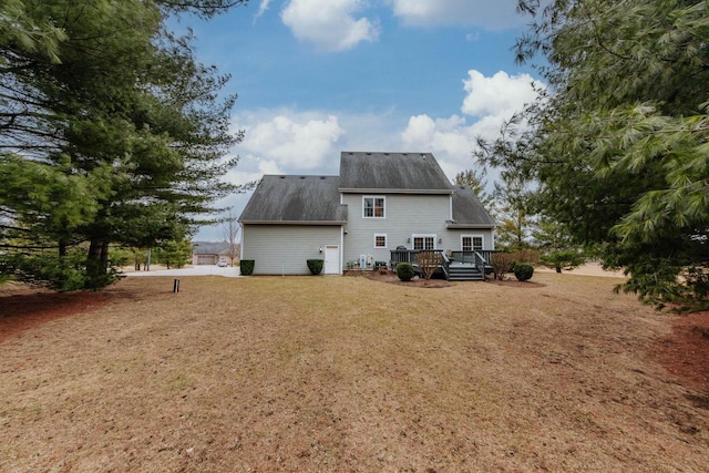 back of house with a yard and a wooden deck