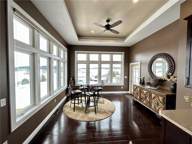 1747 E Drinkman Ln, Eau Claire, WI 54701 - dining room with visible vents, baseboards, a raised ceiling, ceiling fan, and dark wood-type flooring