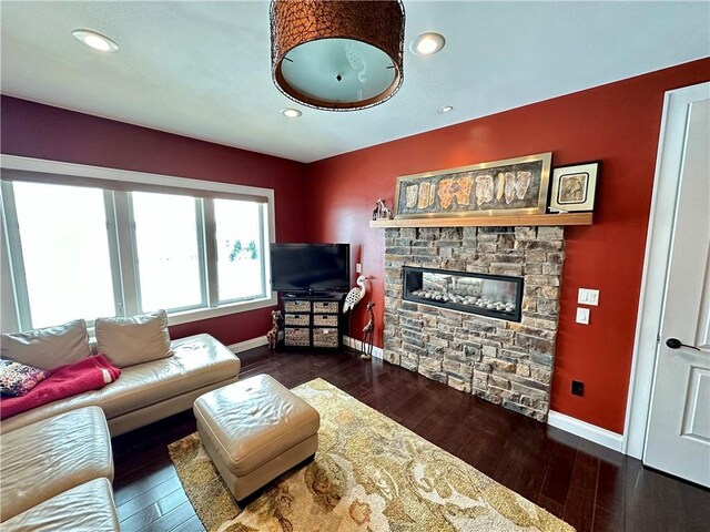 1747 E Drinkman Ln, Eau Claire, WI 54701 - living area featuring recessed lighting, baseboards, a stone fireplace, and hardwood / wood-style flooring