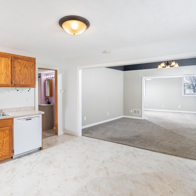 kitchen with white dishwasher, light carpet, visible vents, light countertops, and brown cabinetry