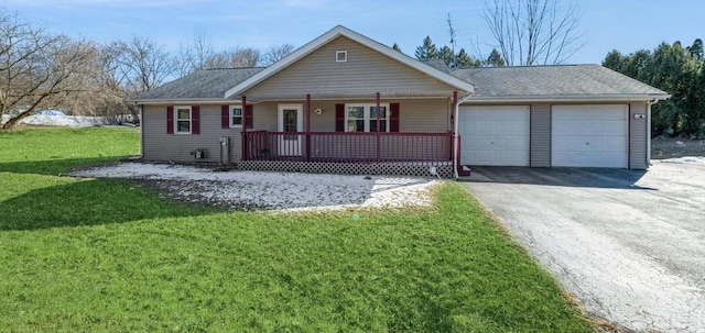 single story home featuring aphalt driveway, covered porch, a garage, a shingled roof, and a front yard