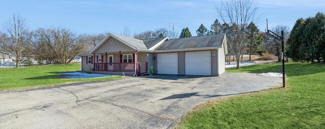 ranch-style house featuring an attached garage, aphalt driveway, a porch, and a front yard