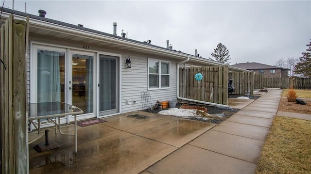 rear view of property with a patio area and fence