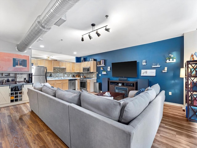 living area featuring baseboards and wood finished floors