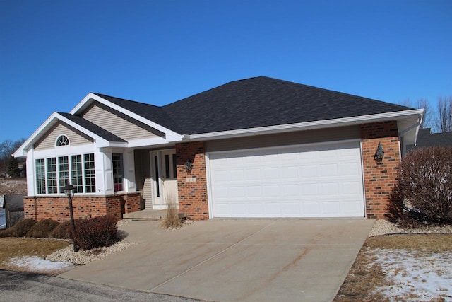 ranch-style home featuring an attached garage, concrete driveway, brick siding, and a shingled roof