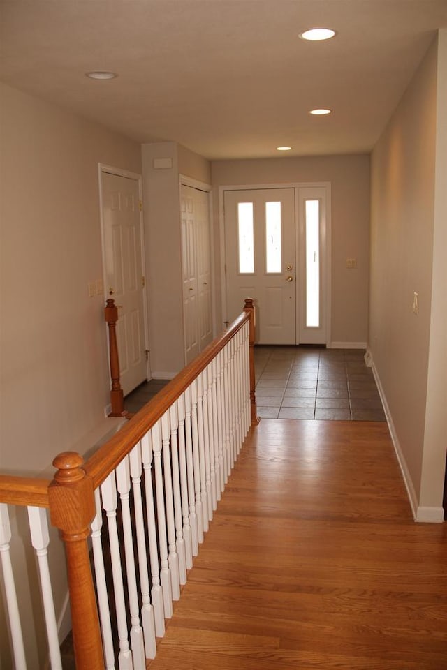 entryway featuring baseboards, wood finished floors, and recessed lighting