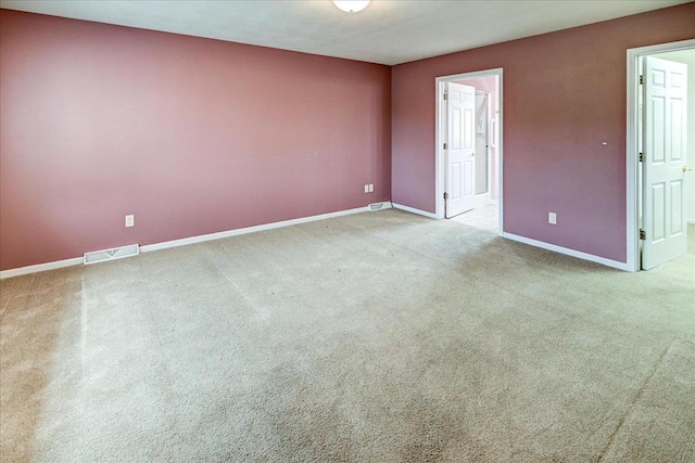 unfurnished room featuring carpet floors, baseboards, and visible vents