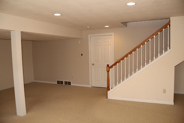 finished basement with recessed lighting, visible vents, carpet flooring, baseboards, and stairs