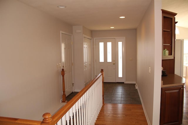 interior space featuring baseboards, dark wood-type flooring, and recessed lighting