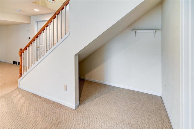 additional living space with recessed lighting, carpet floors, visible vents, baseboards, and stairway