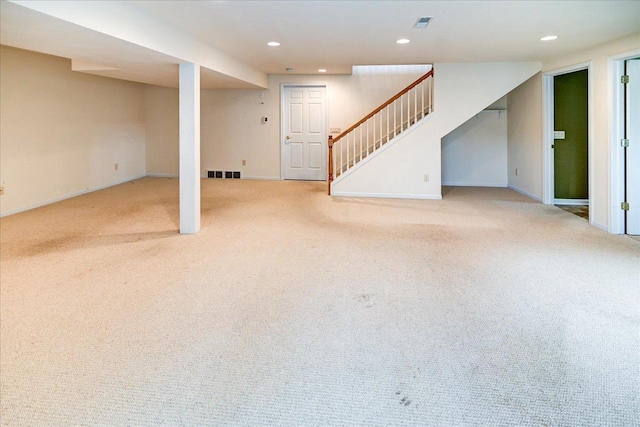 finished basement featuring recessed lighting, visible vents, carpet flooring, and stairs