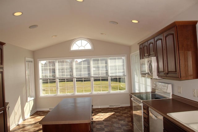 kitchen featuring plenty of natural light, lofted ceiling, dishwasher, and electric range oven