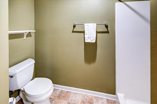 bathroom featuring toilet and baseboards