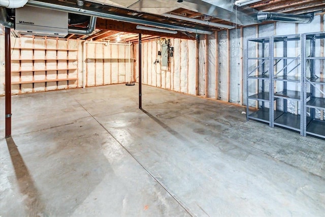 unfinished basement featuring electric panel