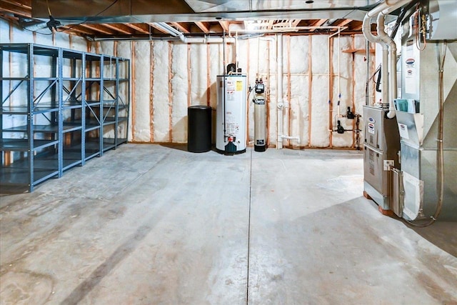 unfinished below grade area featuring gas water heater and heating unit