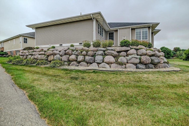 view of side of property with a yard