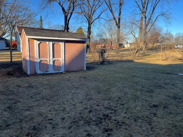 view of shed featuring fence