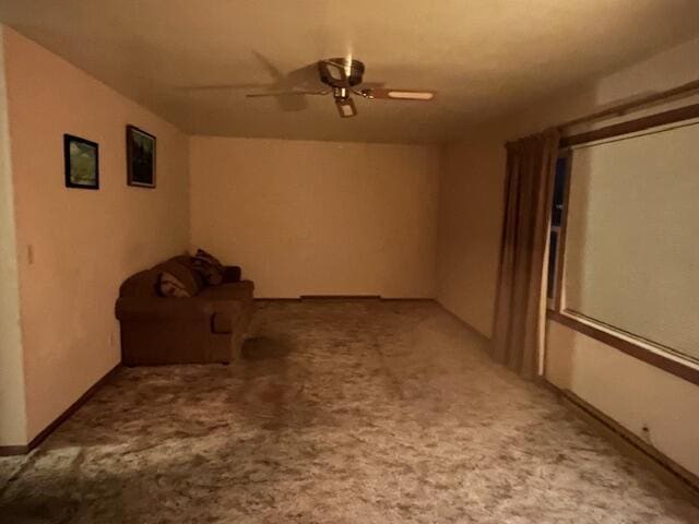 interior space featuring a ceiling fan and light colored carpet