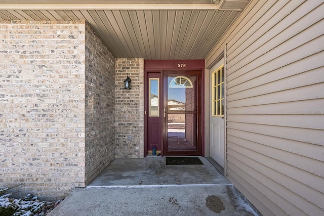 property entrance with brick siding