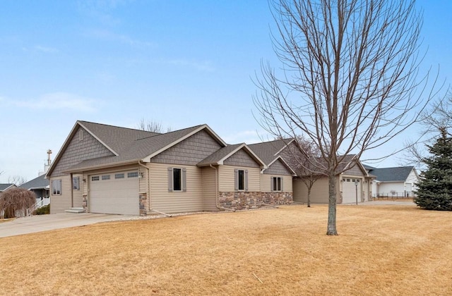 craftsman-style home featuring driveway, stone siding, a garage, and a front yard