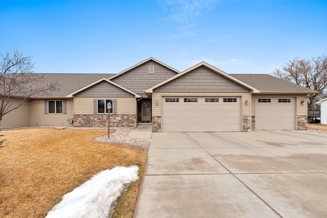 view of front facade featuring driveway, a shingled roof, stone siding, an attached garage, and a front lawn