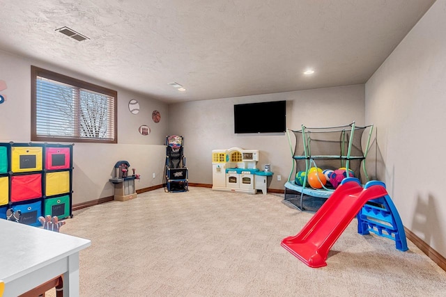 rec room featuring carpet floors, visible vents, and baseboards