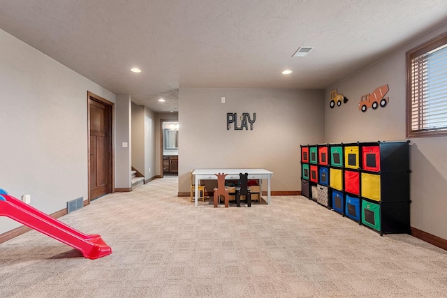 recreation room with carpet, baseboards, and visible vents