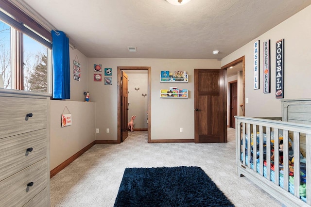 bedroom featuring baseboards and light colored carpet