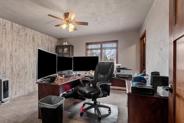 office area with a textured ceiling, a ceiling fan, and carpet flooring