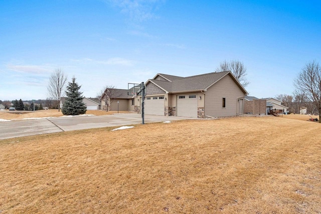 view of front of home with a garage, stone siding, a front lawn, and concrete driveway