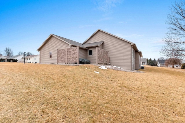 rear view of property featuring a yard