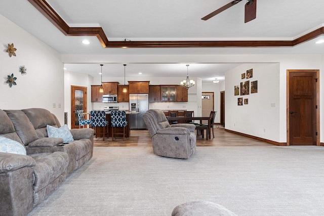 living area with recessed lighting, crown molding, baseboards, and ceiling fan with notable chandelier