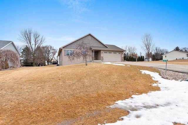 view of front of property with an attached garage, a front lawn, and concrete driveway