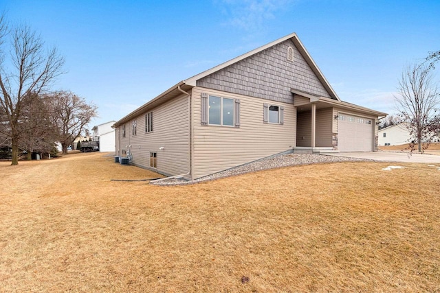 ranch-style home with driveway, a front lawn, an attached garage, and cooling unit