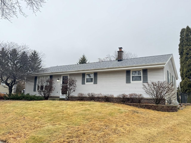 single story home with a front yard and a chimney