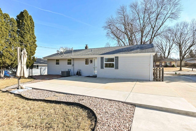 rear view of house featuring a patio area, central AC, and fence