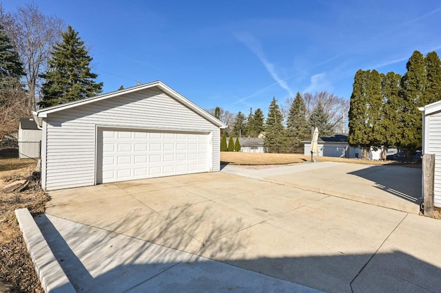 detached garage featuring fence