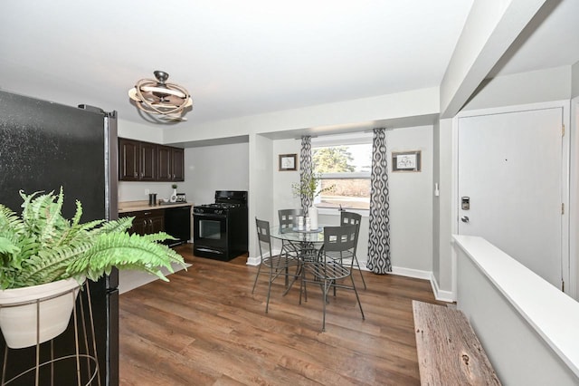 dining room featuring baseboards and dark wood-style flooring