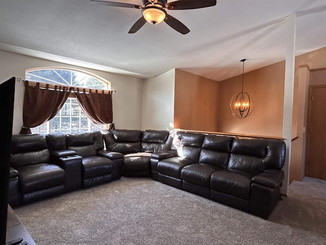 cinema room with vaulted ceiling, carpet floors, and ceiling fan with notable chandelier