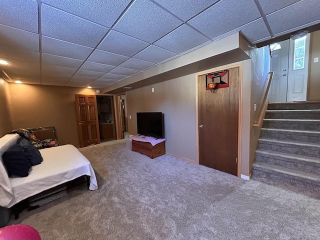 carpeted bedroom with baseboards and a drop ceiling