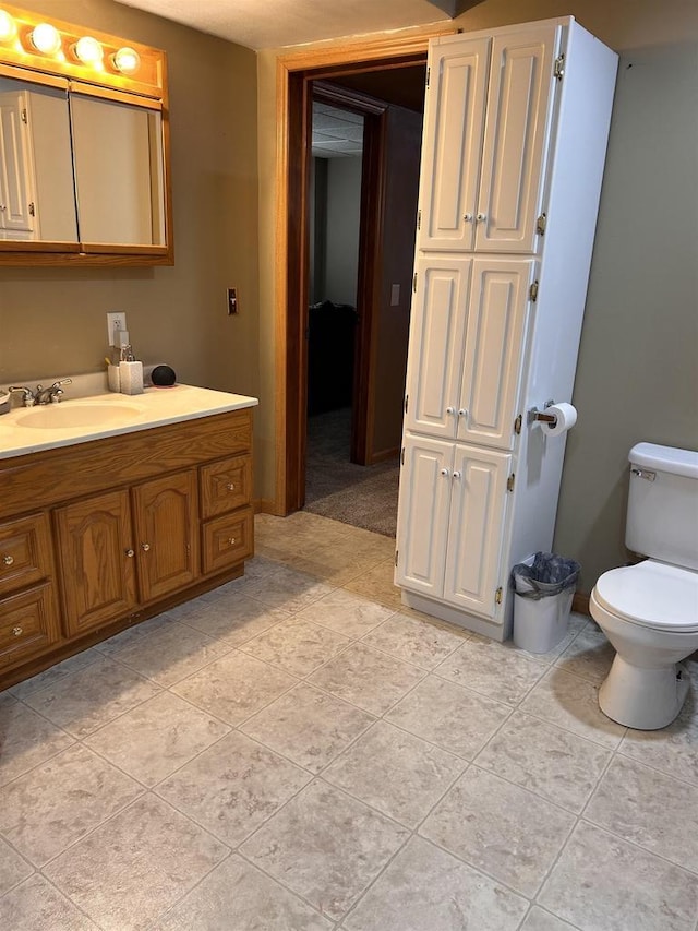 bathroom featuring vanity, toilet, and tile patterned floors