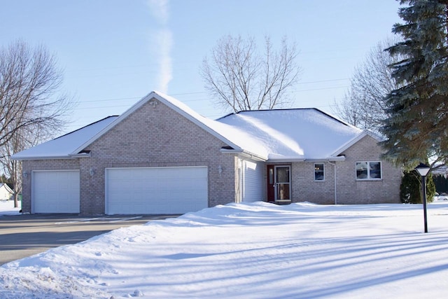 view of front of property with a garage and brick siding