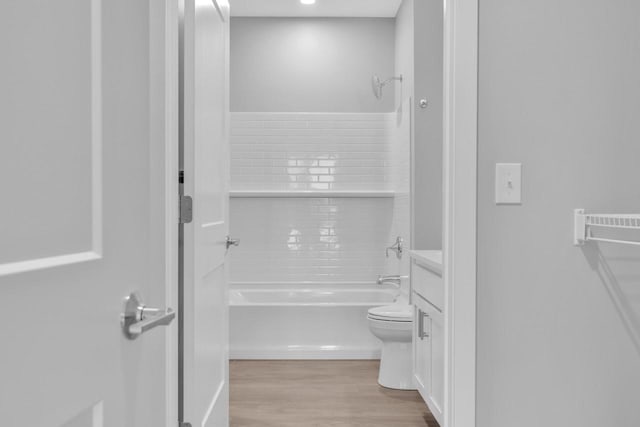 full bathroom featuring bathtub / shower combination, vanity, toilet, and wood finished floors