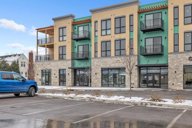 view of property featuring uncovered parking