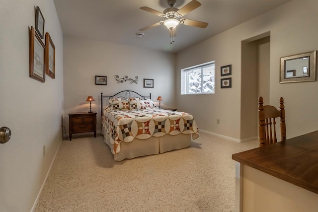 bedroom with a ceiling fan and baseboards